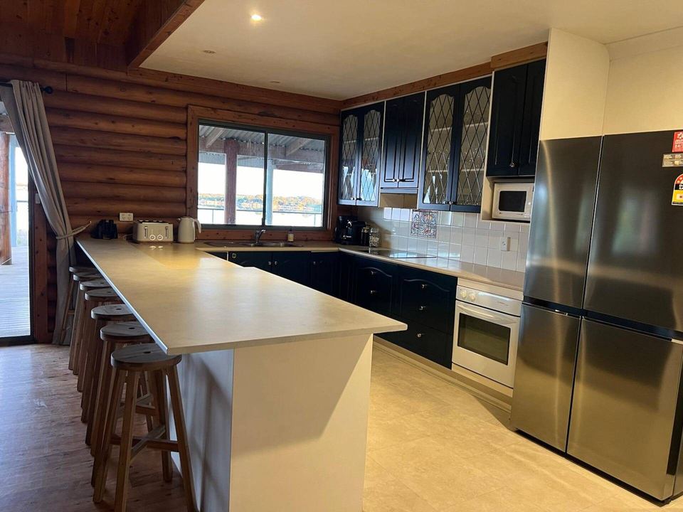 Kitchen with island bench and breakfast stools